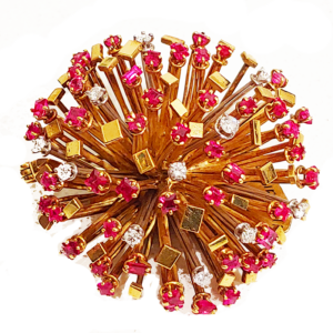 Gold, ruby and diamond starburst brooch by Andrew Grima