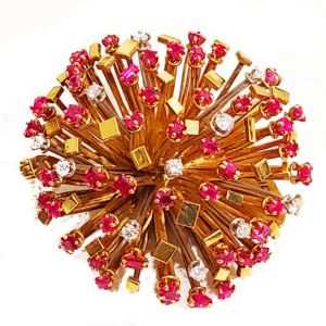 Gold, ruby and diamond starburst brooch by Andrew Grima