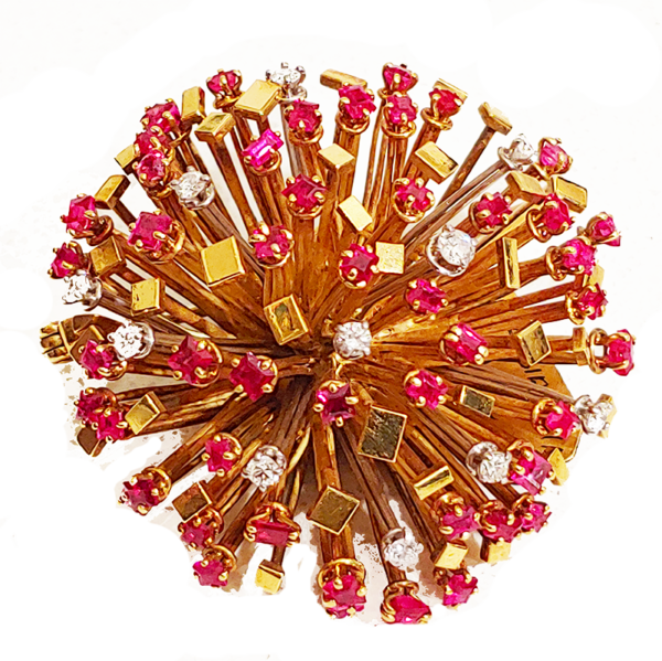 Gold, ruby and diamond starburst brooch by Andrew Grima