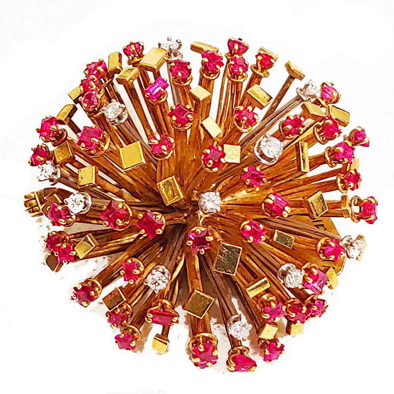 Gold, ruby and diamond starburst brooch by Andrew Grima