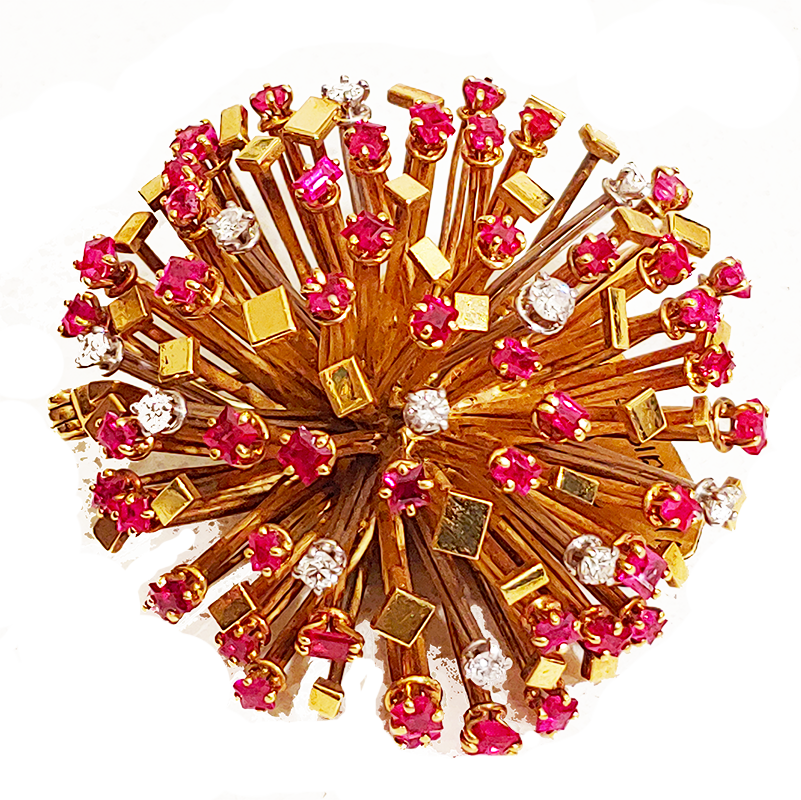 Gold, ruby and diamond starburst brooch by Andrew Grima